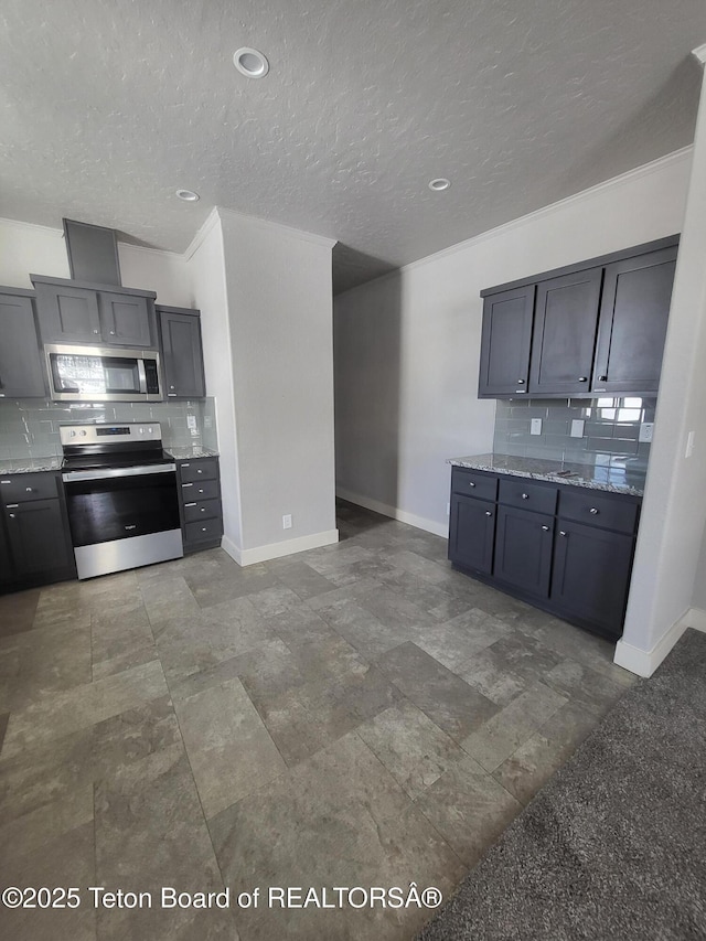 360 Wooden Spur Dr, Alpine, WY 83128 - kitchen with stainless steel appliances, decorative backsplash, light stone countertops, and a textured ceiling
