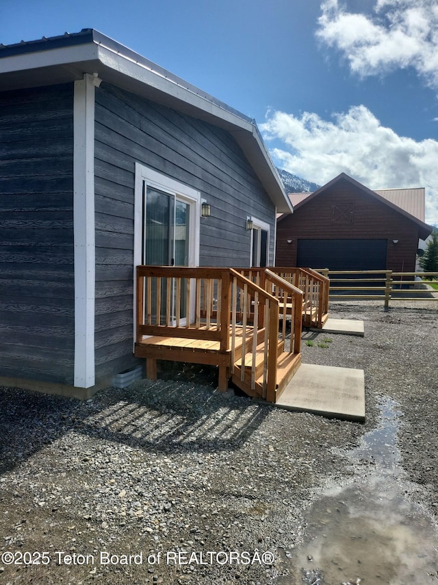 360 Wooden Spur Dr, Alpine, WY 83128 - rear view of property featuring an outbuilding and a deck
