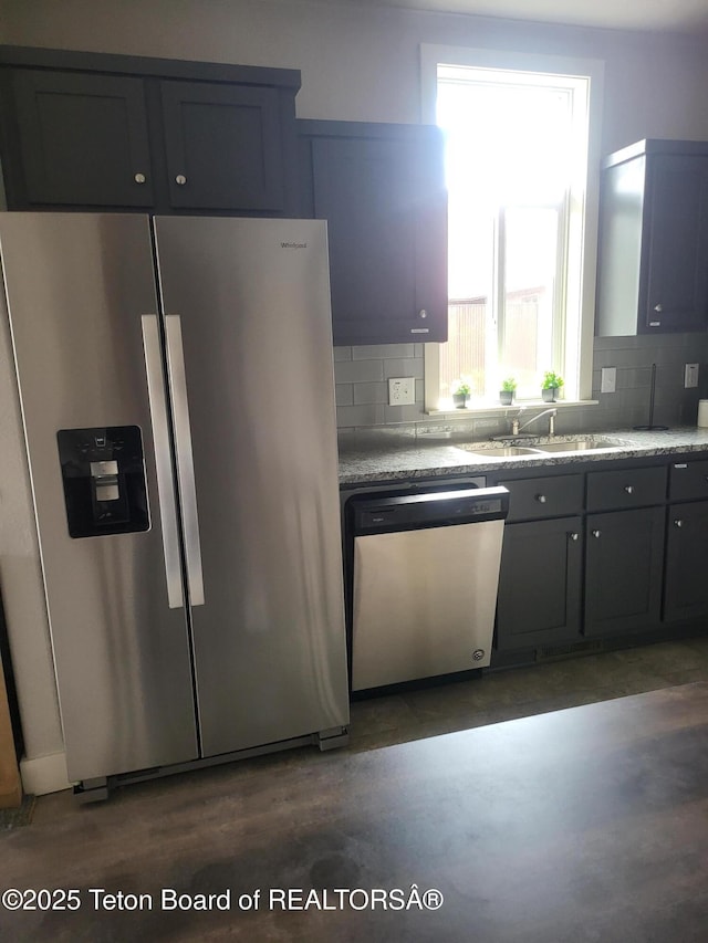 360 Wooden Spur Dr, Alpine, WY 83128 - kitchen featuring stainless steel appliances, backsplash, and concrete floors