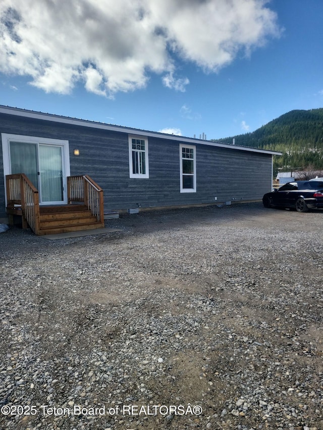 360 Wooden Spur Dr, Alpine, WY 83128 - rear view of house with a mountain view and a metal roof