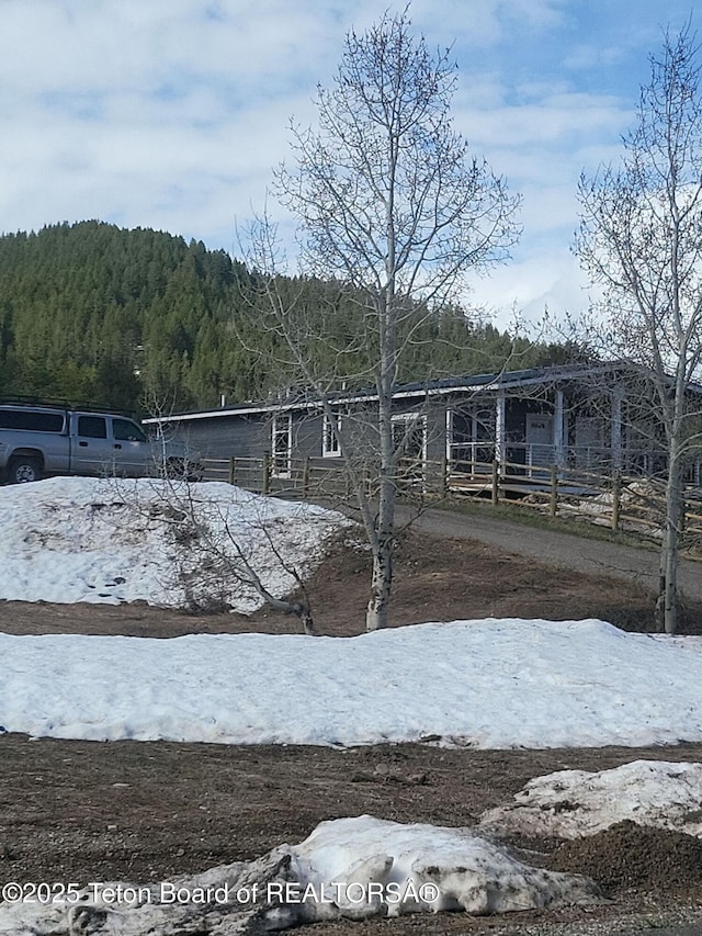 360 Wooden Spur Dr, Alpine, WY 83128 - view of front of home with a wooded view
