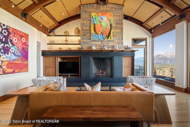 1987 N Spirit Dance Rd, Jackson, WY 83001 - living area with wood finished floors, vaulted ceiling, baseboards, and a fireplace