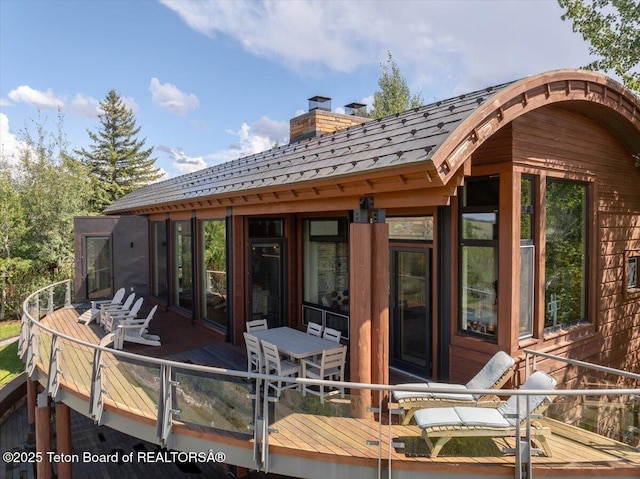 1987 N Spirit Dance Rd, Jackson, WY 83001 - rear view of property featuring a chimney and a wooden deck