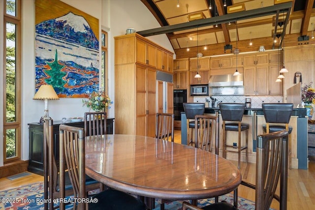 1987 N Spirit Dance Rd, Jackson, WY 83001 - dining area featuring light wood-style flooring, plenty of natural light, high vaulted ceiling, and beam ceiling