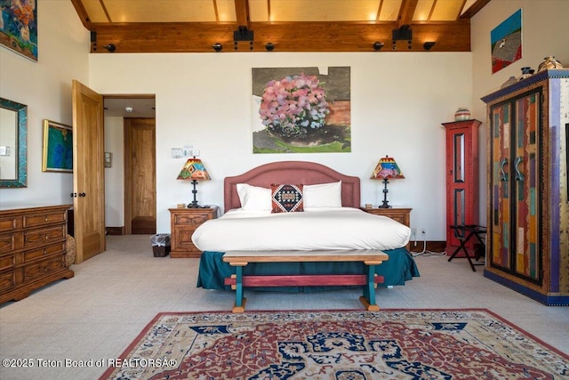 1987 N Spirit Dance Rd, Jackson, WY 83001 - bedroom with light colored carpet, beam ceiling, and a towering ceiling