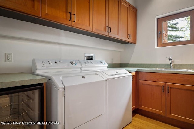 1987 N Spirit Dance Rd, Jackson, WY 83001 - washroom with washer and clothes dryer, cabinet space, and light wood-style floors