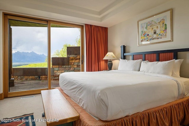 1987 N Spirit Dance Rd, Jackson, WY 83001 - bedroom featuring access to outside, multiple windows, a mountain view, and carpet floors
