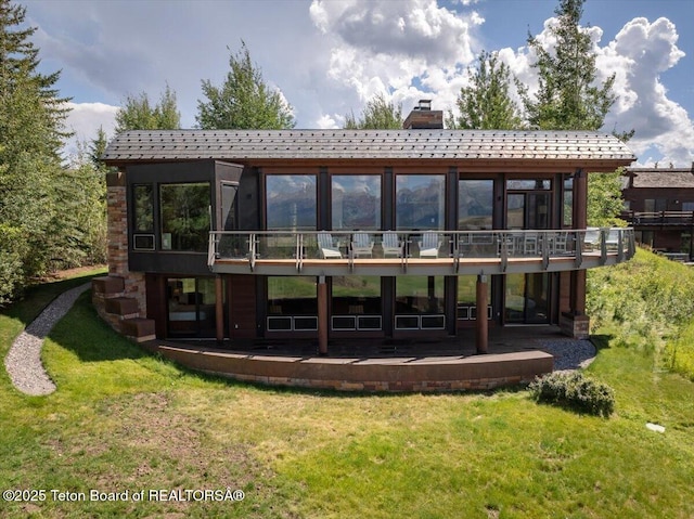 1987 N Spirit Dance Rd, Jackson, WY 83001 - rear view of house featuring a chimney, a yard, and a patio area