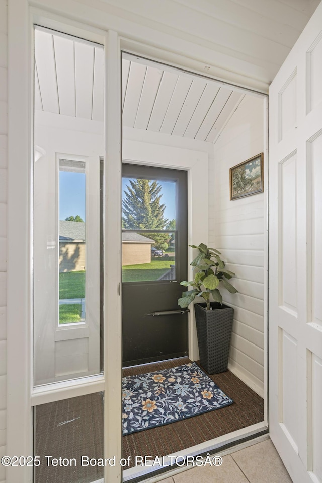 1655 W Big Trail Dr Unit 603, Jackson, WY 83001 - doorway featuring vaulted ceiling, healthy amount of natural light, and tile patterned floors