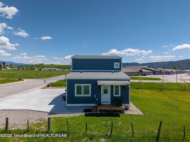 315 Meyers St, Thayne, WY 83127 - back of house with a mountain view, a yard, and a shingled roof