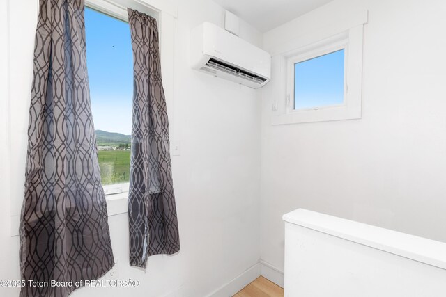 315 Meyers St, Thayne, WY 83127 - interior space with a wall mounted air conditioner and light wood-type flooring