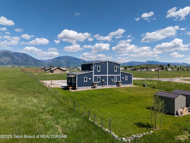 315 Meyers St, Thayne, WY 83127 - rear view of house with a mountain view, a storage shed, and a rural view