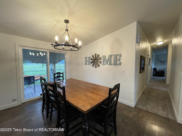 350 Worton Ln, Auburn, WY 83111 - dining space with a chandelier, dark wood-type flooring, and baseboards