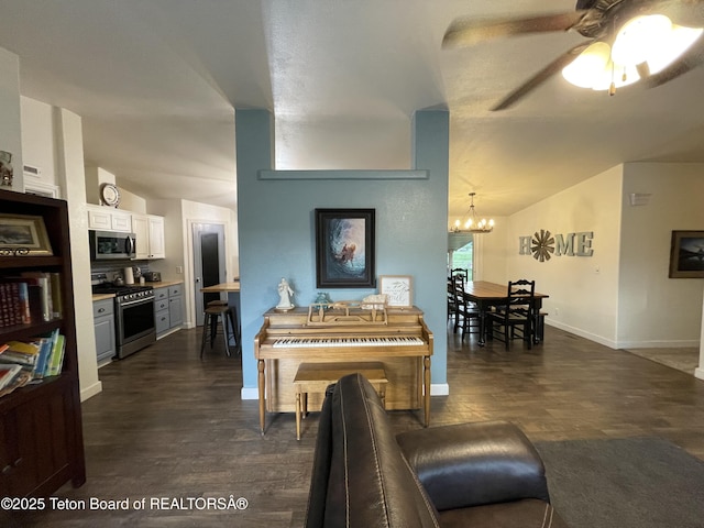 350 Worton Ln, Auburn, WY 83111 - living area with a chandelier, ceiling fan, dark wood finished floors, baseboards, and vaulted ceiling
