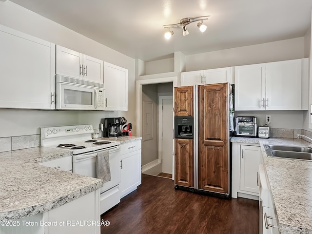 566 Jefferson St, Afton, WY 83110 - kitchen with white appliances, dark wood-style floors, light countertops, and white cabinetry