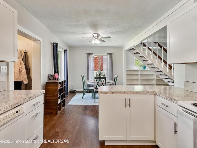 566 Jefferson St, Afton, WY 83110 - kitchen featuring ceiling fan, white appliances, light countertops, white cabinetry, and a textured ceiling