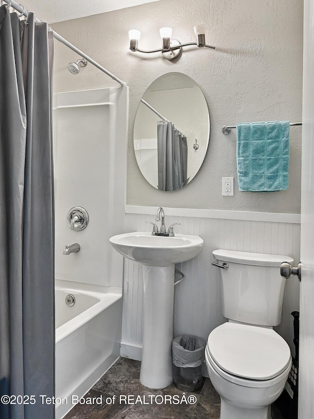 566 Jefferson St, Afton, WY 83110 - bathroom featuring shower / bath combo with shower curtain and a wainscoted wall