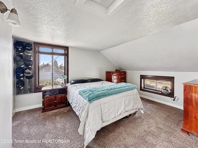 566 Jefferson St, Afton, WY 83110 - carpeted bedroom with a textured ceiling and lofted ceiling