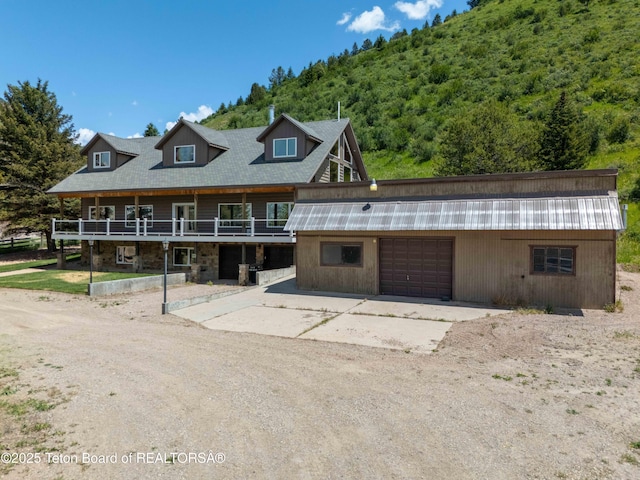 2840 E Dry Crk, Afton, WY 83110 - view of front facade featuring driveway, an attached garage, and a wooden deck
