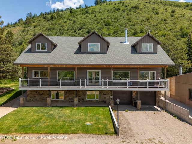2840 E Dry Crk, Afton, WY 83110 - view of front of property with a front lawn, gravel driveway, a garage, and a forest view