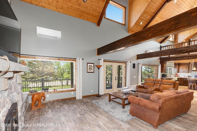 2840 E Dry Crk, Afton, WY 83110 - living room featuring a wall unit AC, high vaulted ceiling, wood finished floors, a wooden ceiling with exposed beams, and french doors