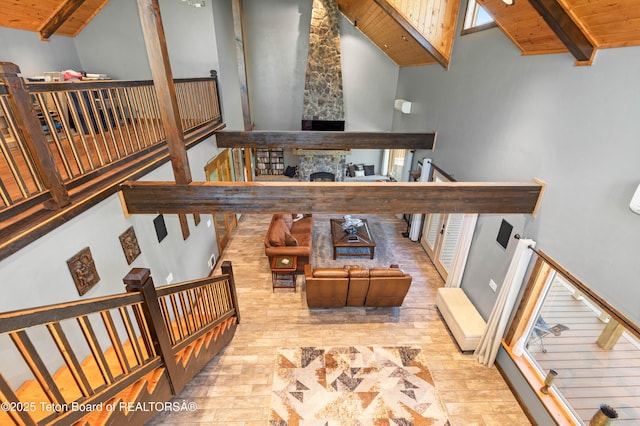 2840 E Dry Crk, Afton, WY 83110 - stairs featuring a wooden ceiling with exposed beams, high vaulted ceiling, and a stone fireplace