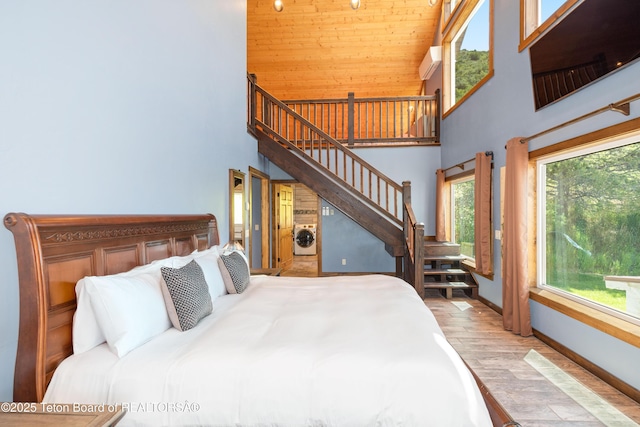 2840 E Dry Crk, Afton, WY 83110 - bedroom with a high ceiling, washer / dryer, multiple windows, and wood finished floors