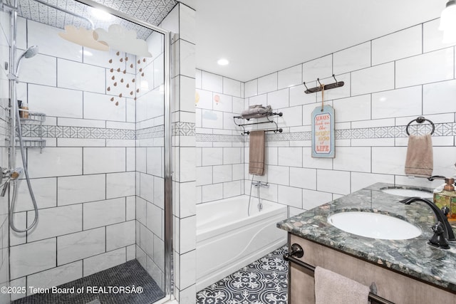 2840 E Dry Crk, Afton, WY 83110 - bathroom with a stall shower, a garden tub, double vanity, tile patterned floors, and tile walls