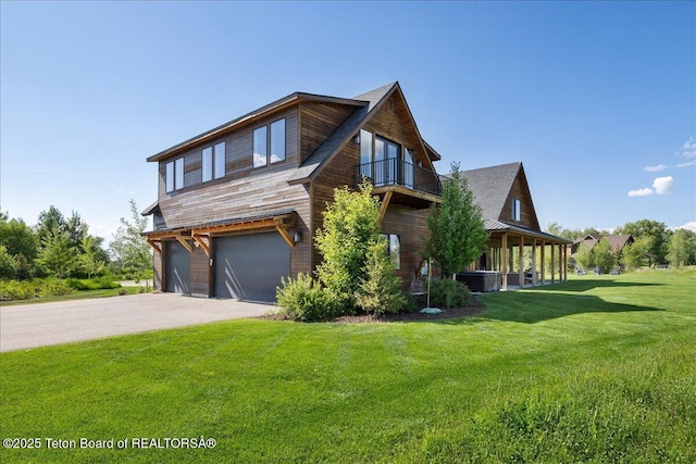 346 S Leigh Ranch Rd, Tetonia, ID 83452 - view of front facade with a balcony, a garage, a front yard, and asphalt driveway