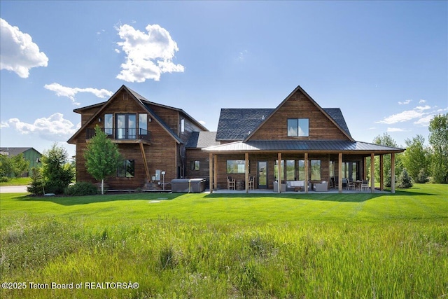346 S Leigh Ranch Rd, Tetonia, ID 83452 - back of property with a patio, a hot tub, a lawn, and a metal roof