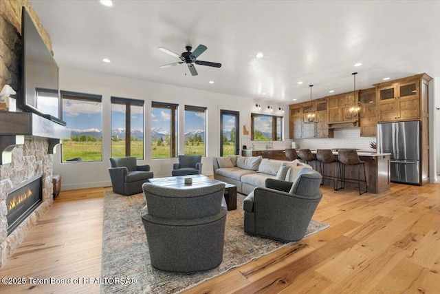 346 S Leigh Ranch Rd, Tetonia, ID 83452 - living area with recessed lighting, a stone fireplace, light wood-type flooring, and ceiling fan