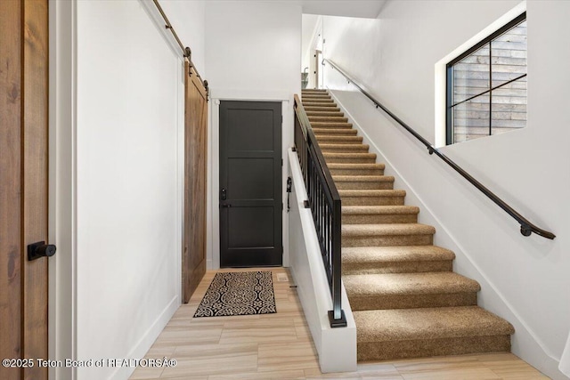 346 S Leigh Ranch Rd, Tetonia, ID 83452 - staircase featuring a barn door and wood finished floors