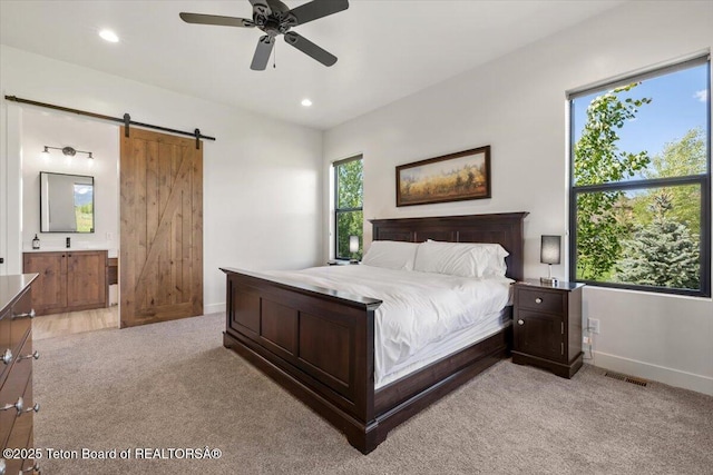 346 S Leigh Ranch Rd, Tetonia, ID 83452 - bedroom with light colored carpet, a barn door, recessed lighting, connected bathroom, and a ceiling fan