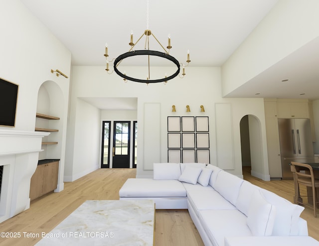7 Cold Springs Rd, Victor, ID 83455 - living area with a chandelier, light wood-style flooring, built in shelves, and arched walkways