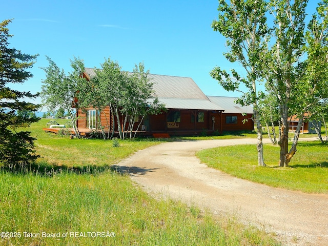 135 Butler Ln, Driggs, ID 83422 - view of front of property featuring curved driveway, a metal roof, and a front yard