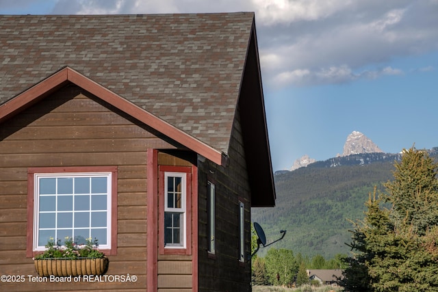 891 Paiute St, Driggs, ID 83422 - view of side of property with a shingled roof and a mountain view