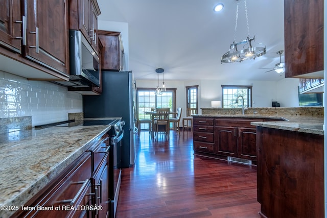 891 Paiute St, Driggs, ID 83422 - kitchen with black range with electric stovetop, healthy amount of natural light, stainless steel microwave, and dark wood-style flooring