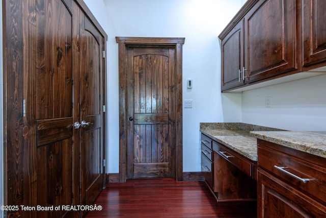 891 Paiute St, Driggs, ID 83422 - kitchen with dark wood finished floors, light stone countertops, and dark brown cabinetry