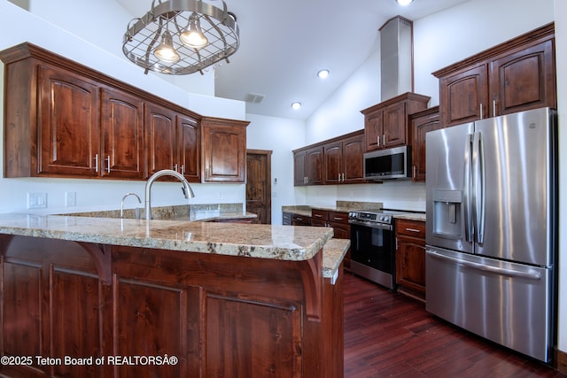 891 Paiute St, Driggs, ID 83422 - kitchen with appliances with stainless steel finishes, a peninsula, dark wood-type flooring, dark brown cabinetry, and high vaulted ceiling