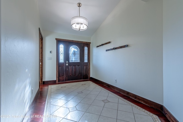 891 Paiute St, Driggs, ID 83422 - foyer with light tile patterned flooring, a chandelier, and inlaid floor details