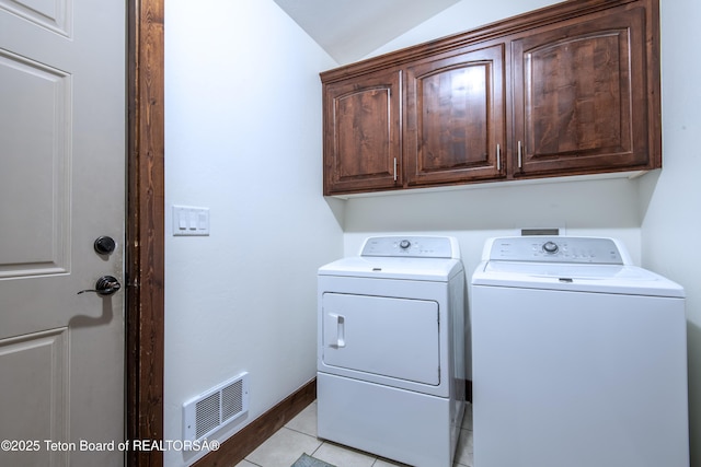 891 Paiute St, Driggs, ID 83422 - washroom featuring washing machine and clothes dryer, cabinet space, and light tile patterned flooring
