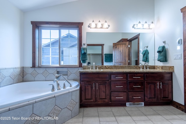 891 Paiute St, Driggs, ID 83422 - full bath featuring double vanity, a garden tub, tile patterned floors, and vaulted ceiling