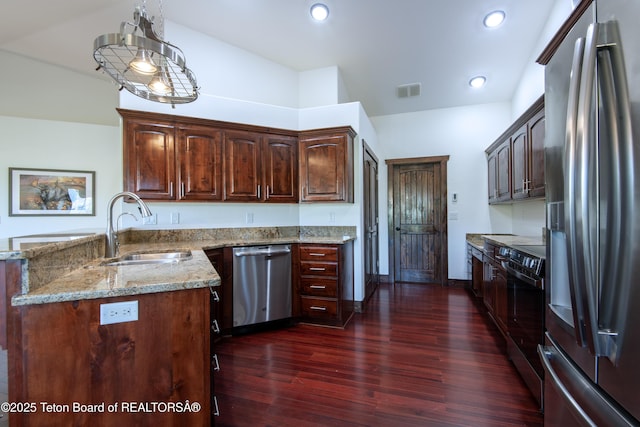 891 Paiute St, Driggs, ID 83422 - kitchen featuring stainless steel appliances, light stone countertops, dark wood-style flooring, a peninsula, and recessed lighting