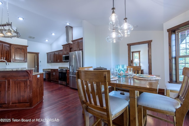 891 Paiute St, Driggs, ID 83422 - dining space featuring lofted ceiling and dark wood-style floors