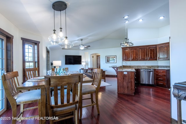 891 Paiute St, Driggs, ID 83422 - dining room with dark wood finished floors, vaulted ceiling, arched walkways, ceiling fan, and recessed lighting