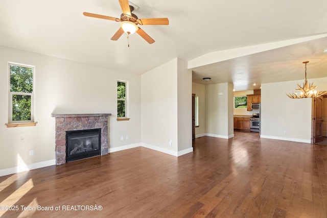 30C Blue Wing Ln, Alpine, WY 83128 - unfurnished living room featuring a chandelier, a fireplace, dark wood finished floors, ceiling fan, and lofted ceiling