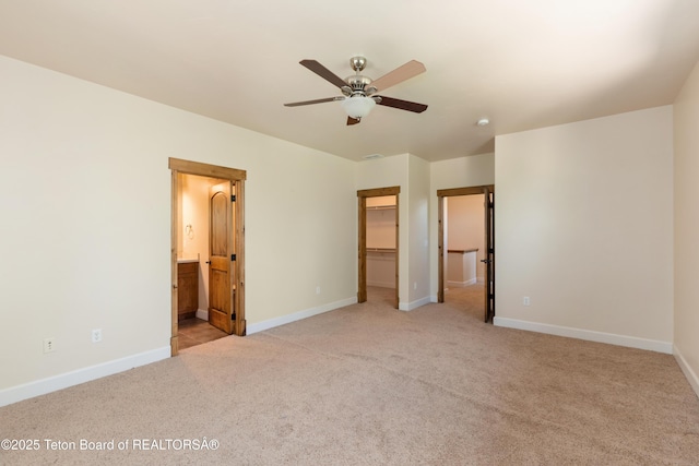 30C Blue Wing Ln, Alpine, WY 83128 - unfurnished bedroom featuring carpet floors, a walk in closet, connected bathroom, a closet, and a ceiling fan