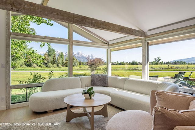 525 E Golf Creek Ln Unit 34, Jackson, WY 83001 - sunroom with lofted ceiling, wood finished floors, a mountain view, a rural view, and an outdoor living space