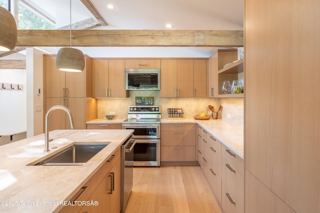 525 E Golf Creek Ln Unit 34, Jackson, WY 83001 - kitchen with appliances with stainless steel finishes, light brown cabinets, tasteful backsplash, and light wood-style floors