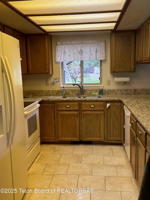 144 Blue Lake Cir, Alpine, WY 83128 - kitchen with white appliances, light stone countertops, and light tile patterned floors